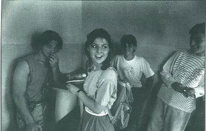 Robert Taylor Brewer photographed A Girl In A Bar With Friends, Tirana, Albania 1992 for My Albania: Ground Zero